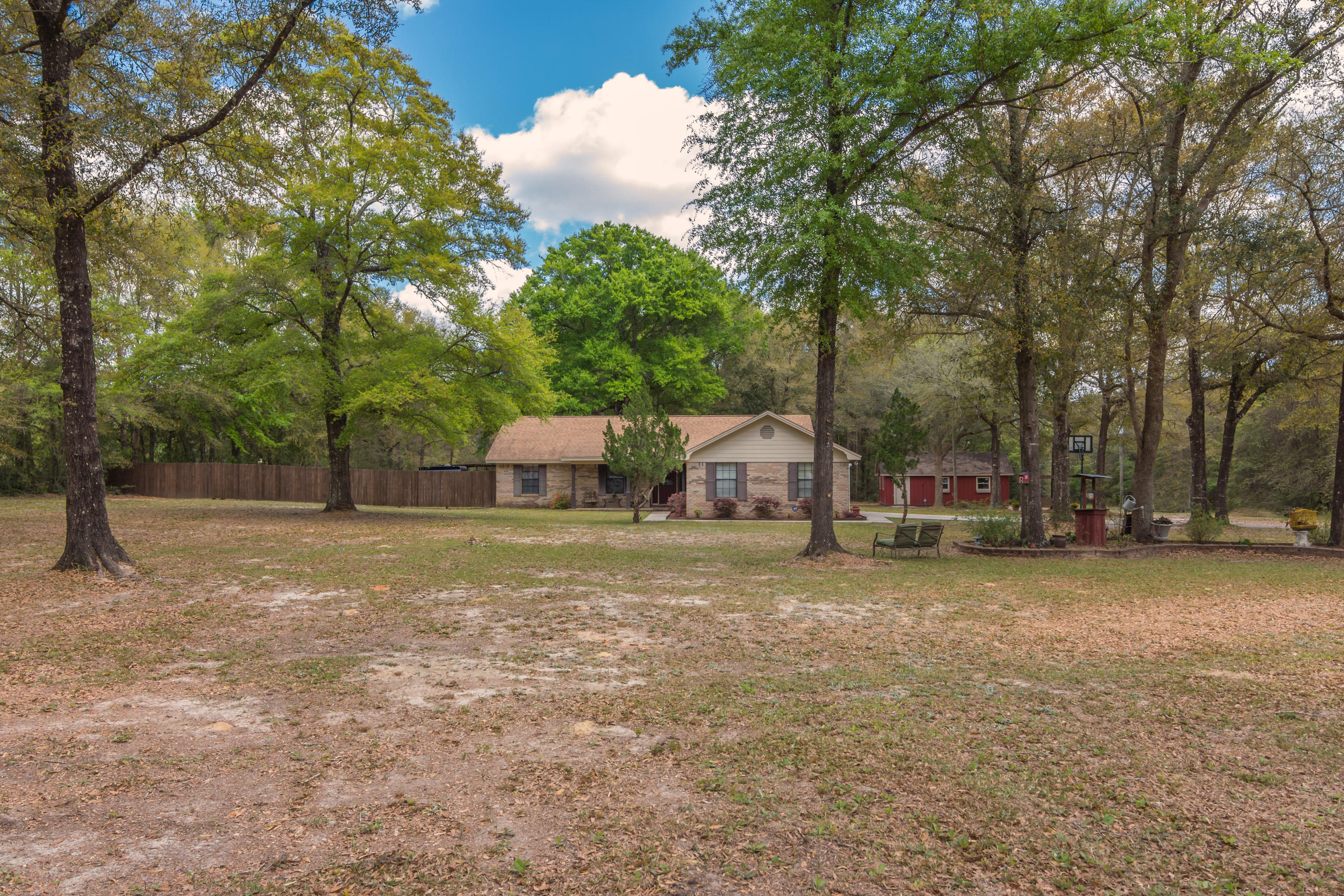 5551 Buckward Road Baker, FL 32531 - Photo 2 of 47 a house with trees in front of it