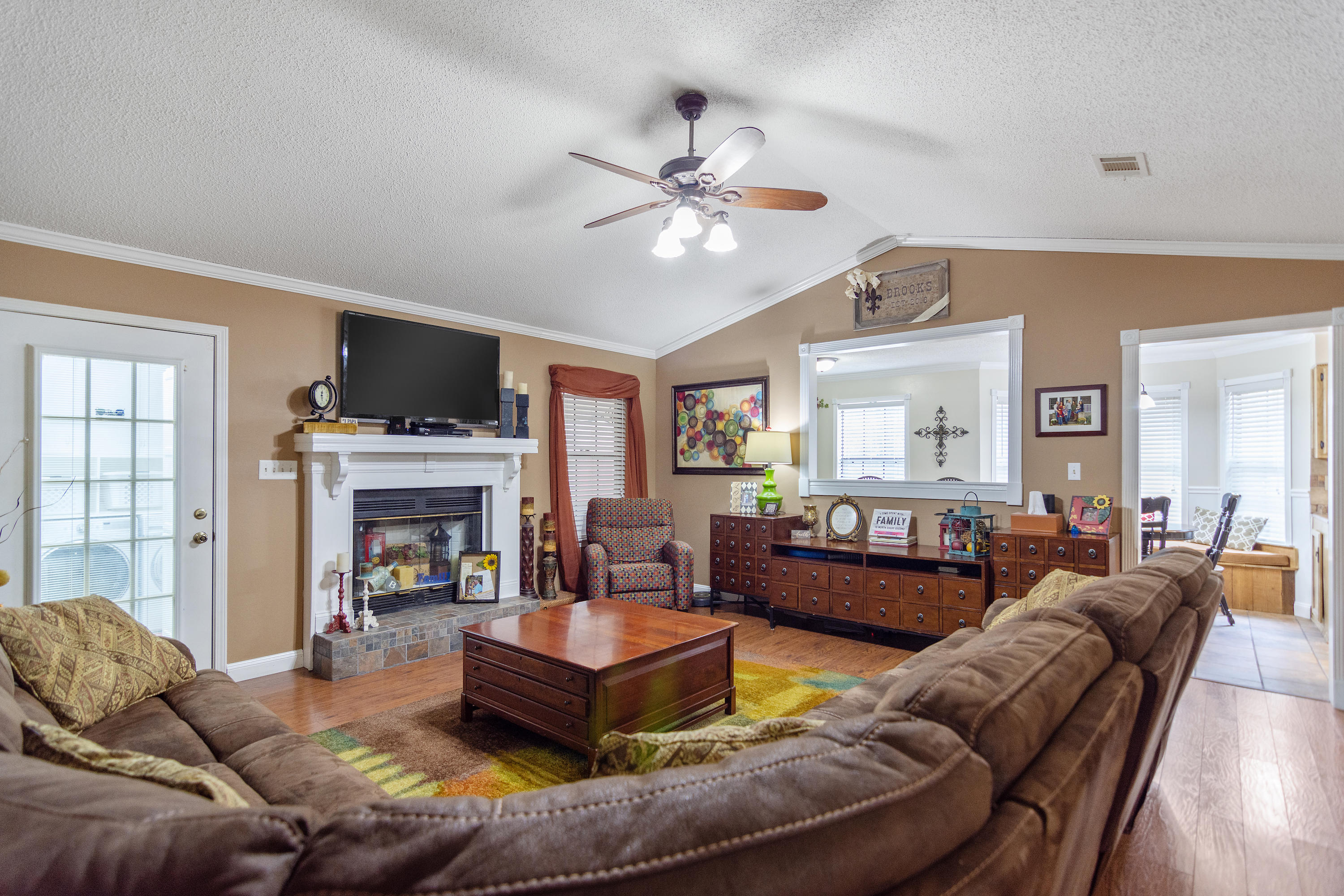 5551 Buckward Road Baker, FL 32531 - Photo 12 of 47 a living room with furniture a fireplace and a flat screen tv