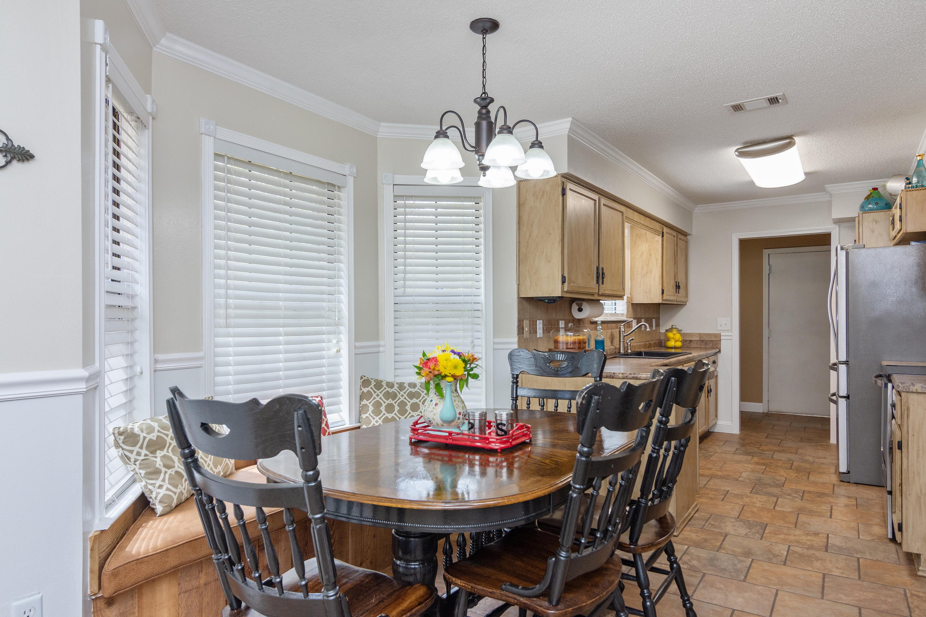 5551 Buckward Road Baker, FL 32531 - Photo 17 of 47 a dining room filled chandelier and kitchen view