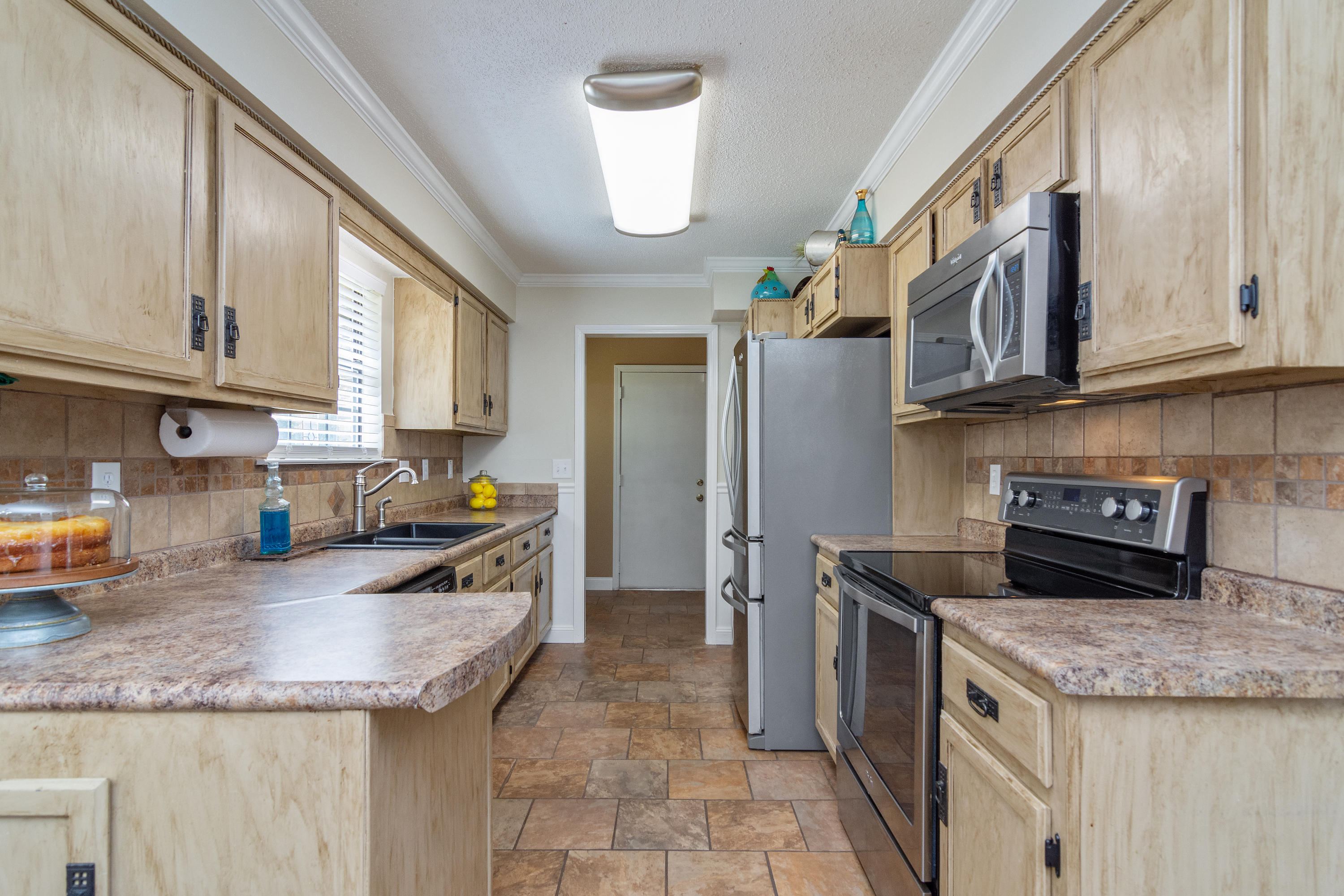 5551 Buckward Road Baker, FL 32531 - Photo 19 of 47 a kitchen with granite countertop a sink a stove and a refrigerator