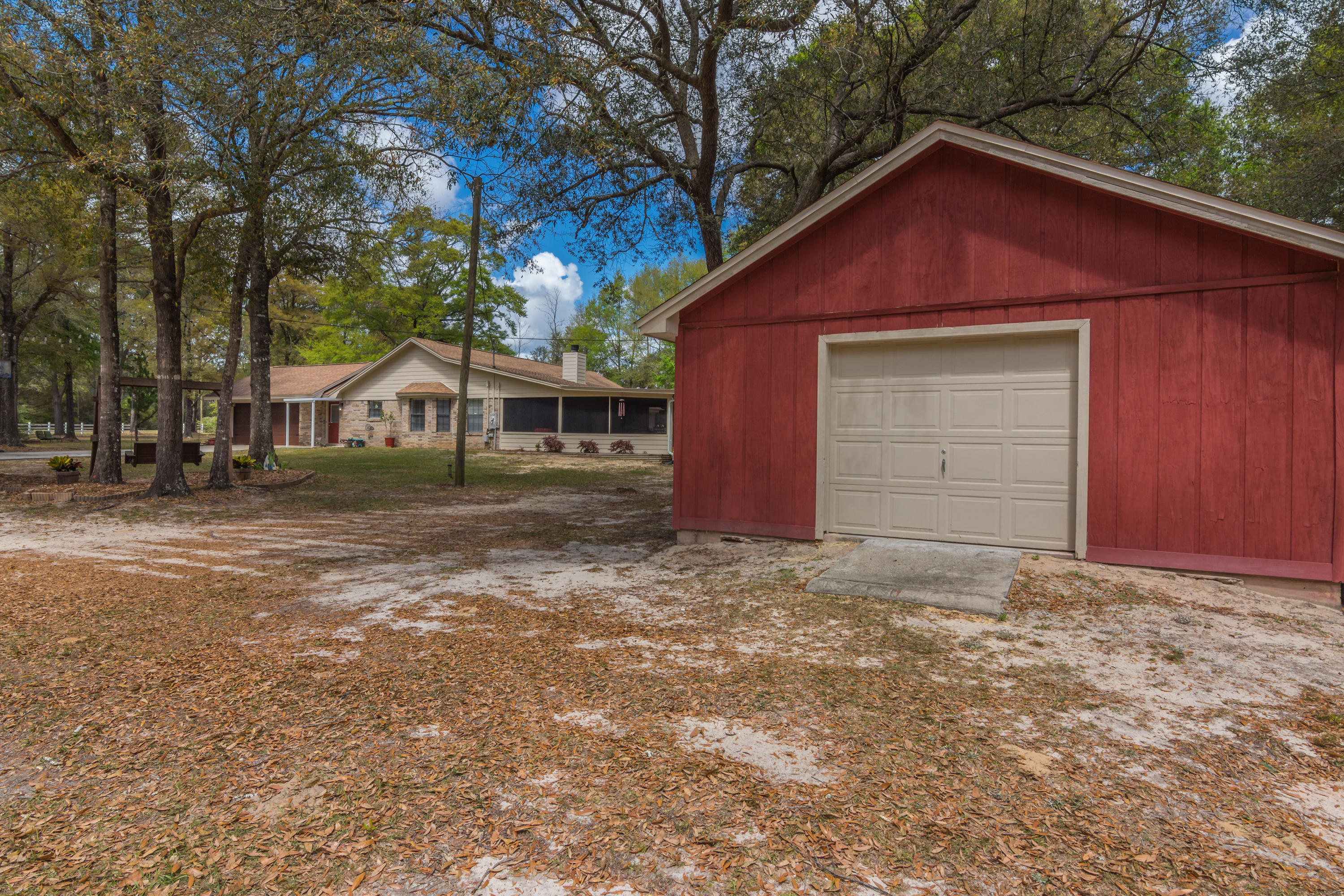 5551 Buckward Road Baker, FL 32531 - Photo 3 of 47 a house with trees in front of it