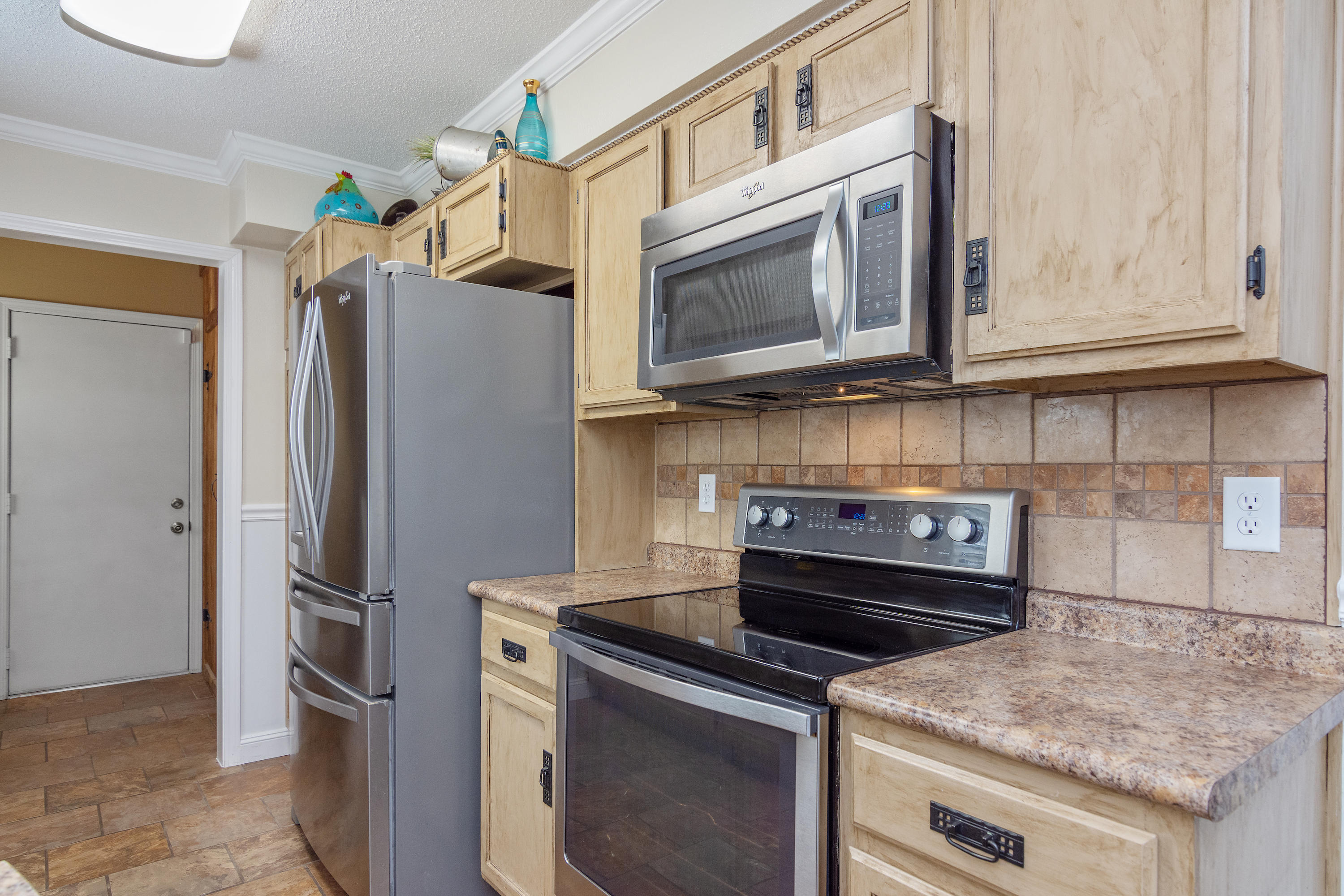 5551 Buckward Road Baker, FL 32531 - Photo 21 of 47 a kitchen with stainless steel appliances granite countertop a stove microwave and refrigerator