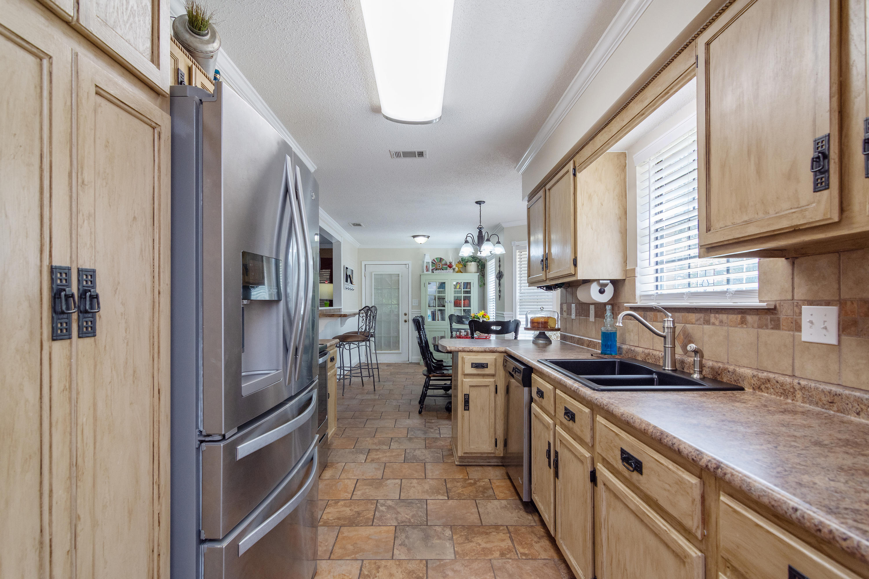 5551 Buckward Road Baker, FL 32531 - Photo 22 of 47 a kitchen with stainless steel appliances granite countertop a sink refrigerator and cabinets