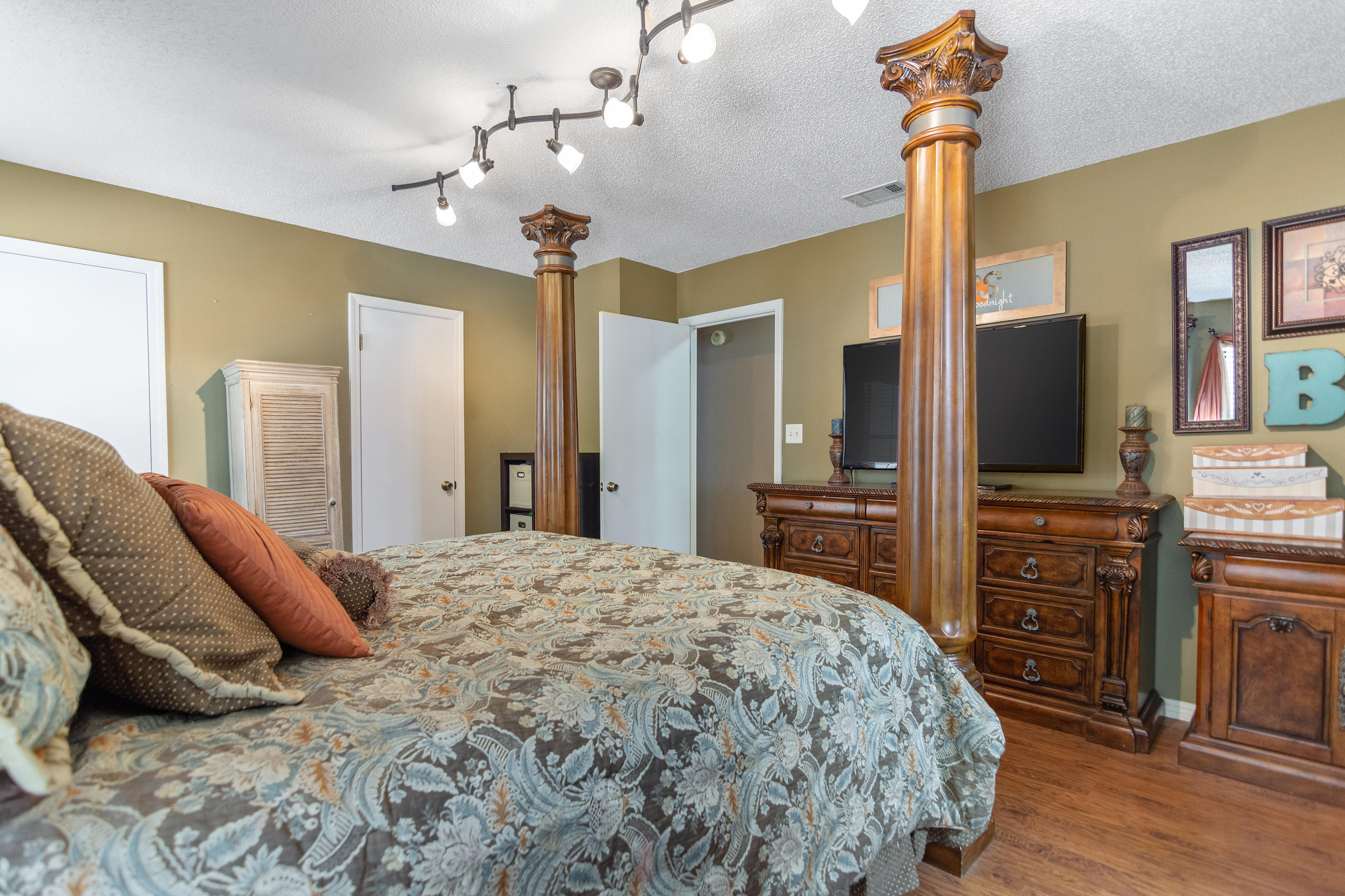 5551 Buckward Road Baker, FL 32531 - Photo 29 of 47 a spacious bedroom with a bed and a flat screen tv