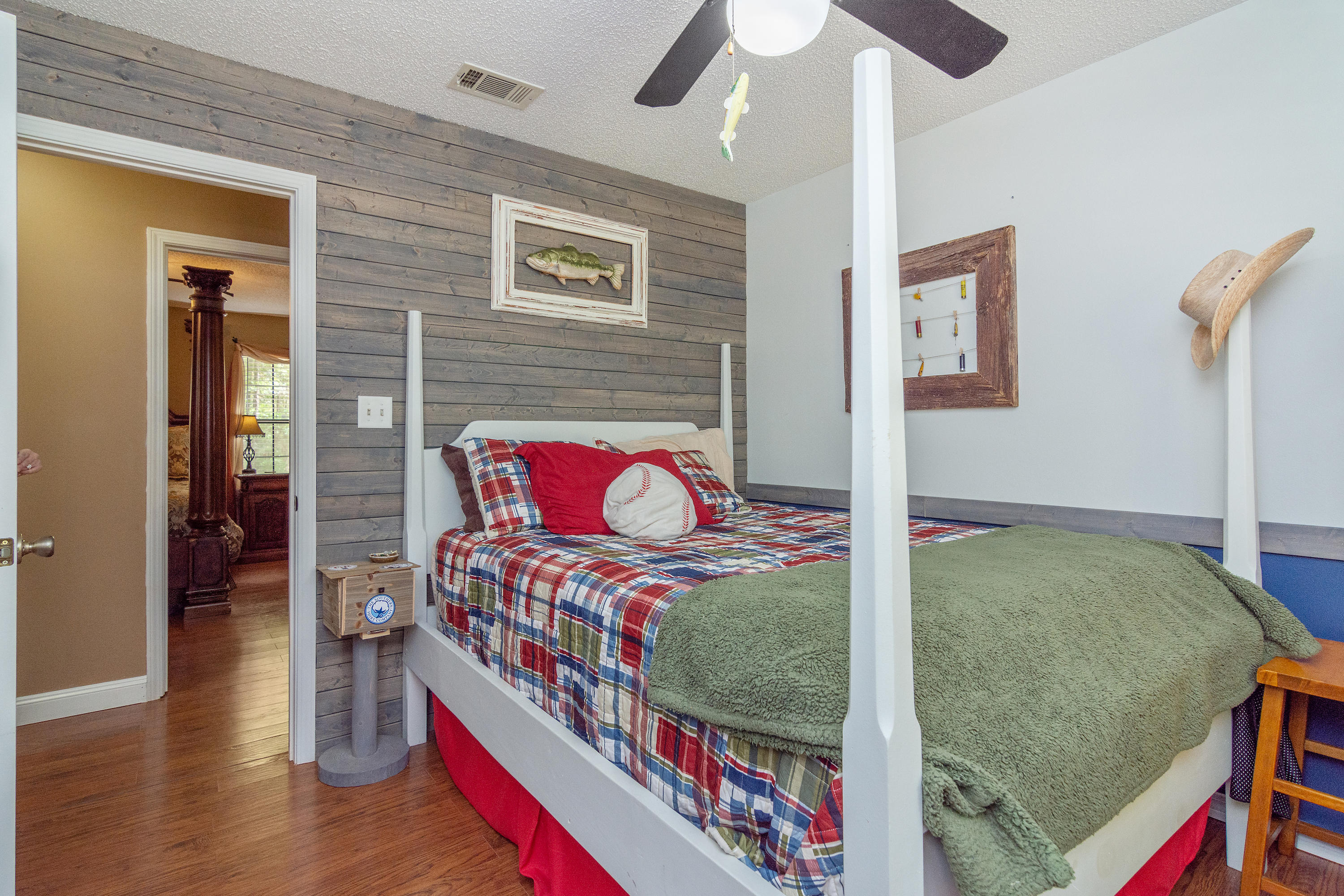 5551 Buckward Road Baker, FL 32531 - Photo 30 of 47 a bed room with a bed and a book shelf