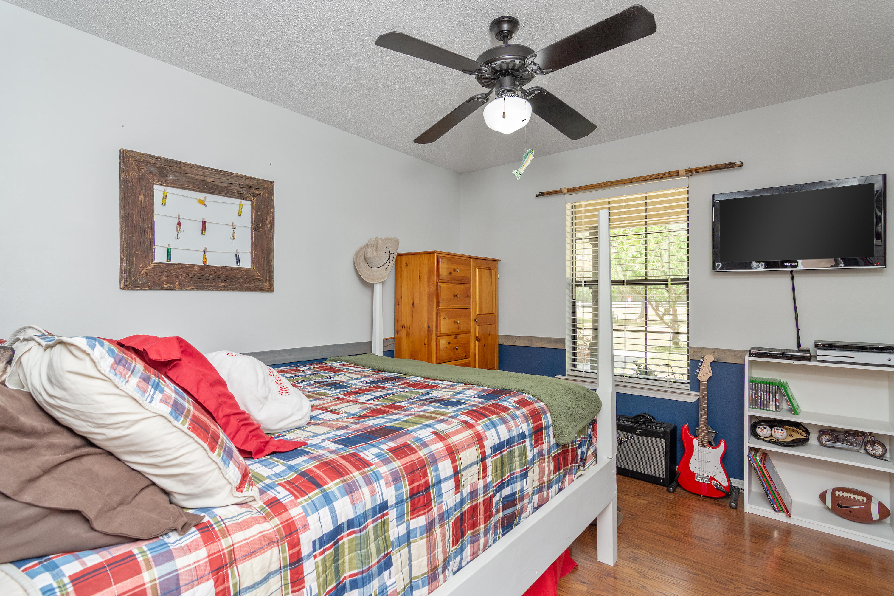 5551 Buckward Road Baker, FL 32531 - Photo 31 of 47 a bedroom with a bed and a flat screen tv