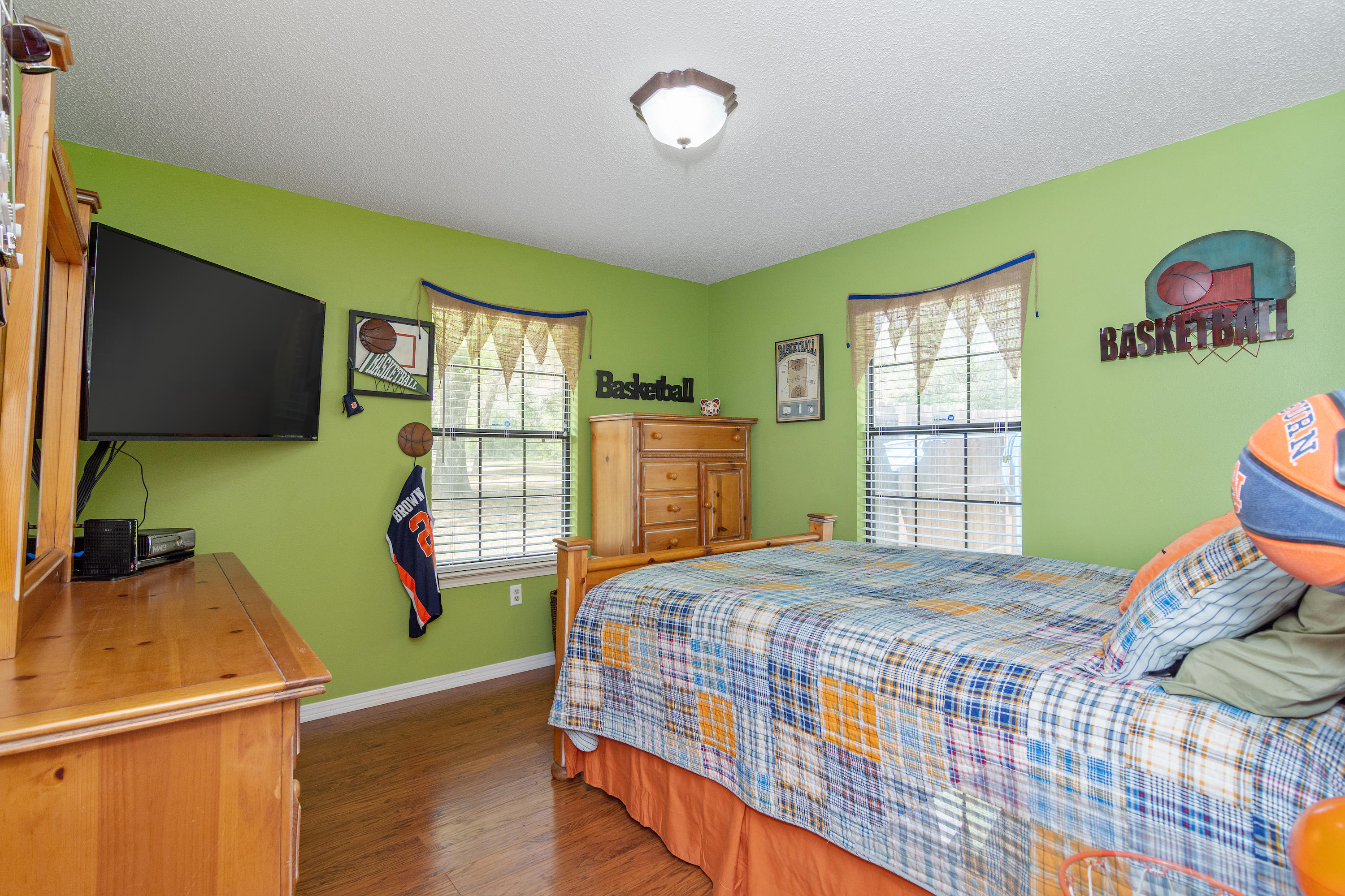 5551 Buckward Road Baker, FL 32531 - Photo 32 of 47 a bedroom with a bed and a flat screen tv