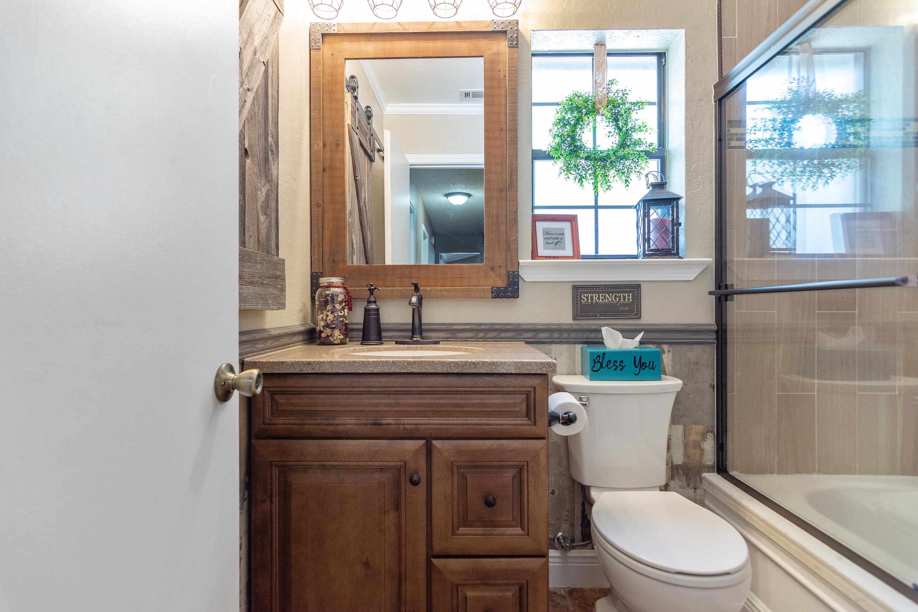 5551 Buckward Road Baker, FL 32531 - Photo 33 of 47 a bathroom with a toilet a sink and a mirror