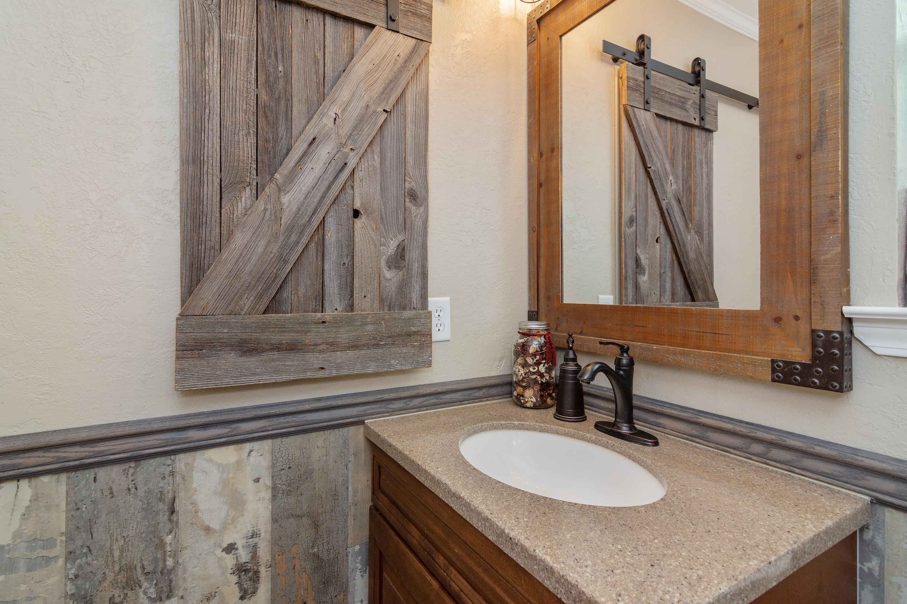 5551 Buckward Road Baker, FL 32531 - Photo 35 of 47 a bathroom with a granite countertop sink and a mirror
