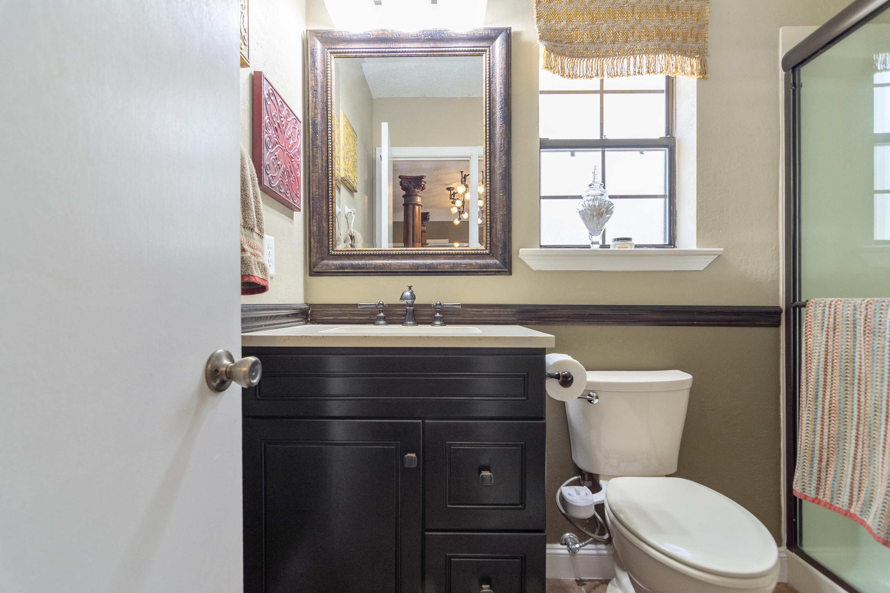 5551 Buckward Road Baker, FL 32531 - Photo 36 of 47 a bathroom with a sink a toilet a mirror and window