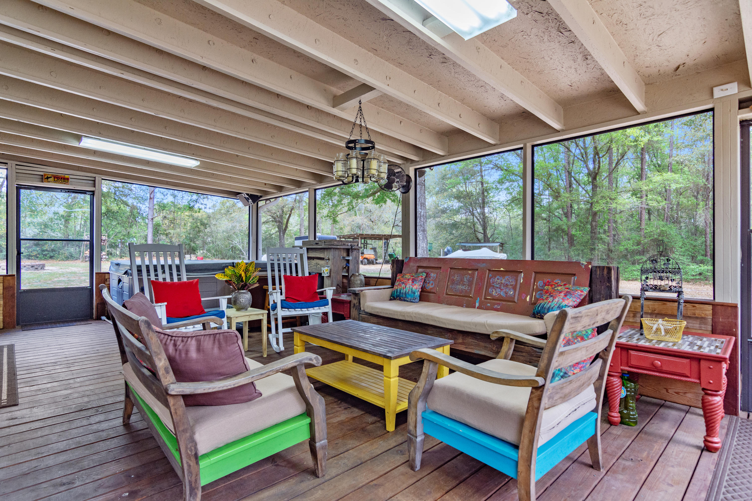 5551 Buckward Road Baker, FL 32531 - Photo 40 of 47 a living room with patio furniture and a floor to ceiling window