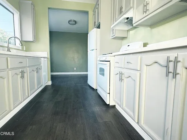 a view of a kitchen with a stove top oven