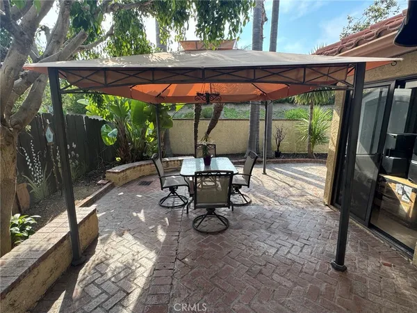 a backyard of a house with table and chairs