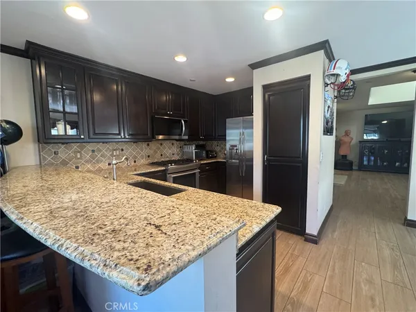a kitchen with a sink refrigerator and microwave