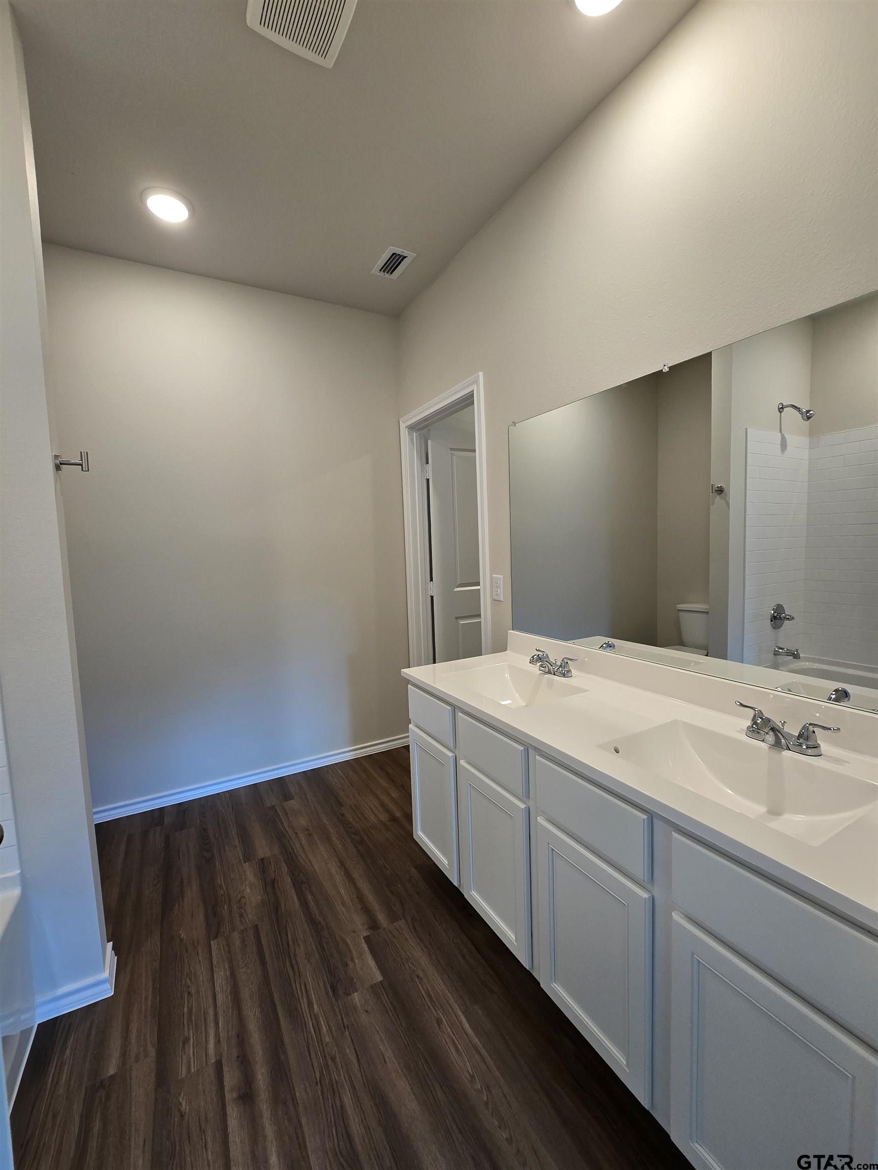 324 Erica Way Lindale, TX 75771 - Photo 13 of 14 a bathroom with a sink and a mirror