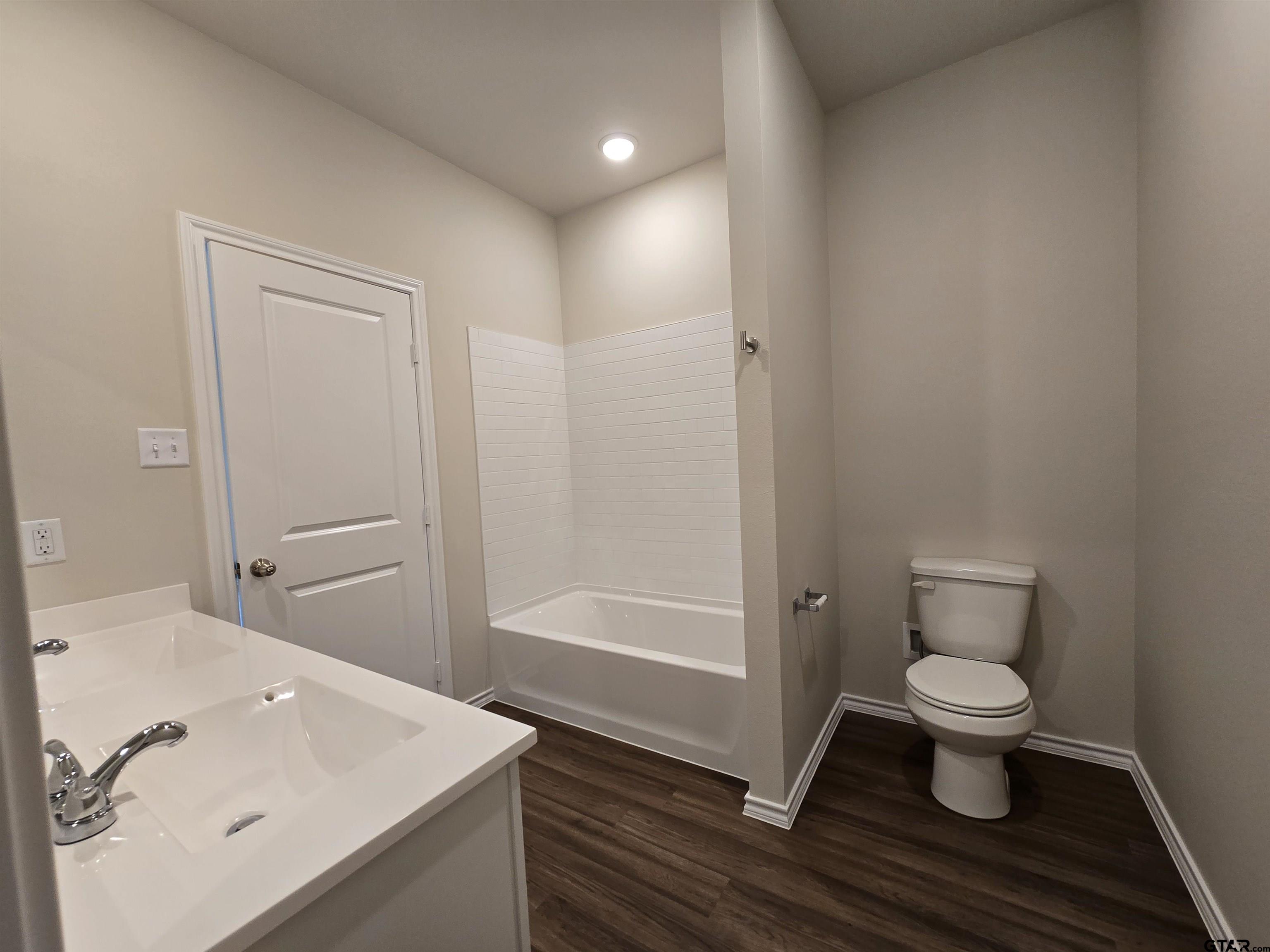 324 Erica Way Lindale, TX 75771 - Photo 14 of 14 a bathroom with a sink a toilet and shower
