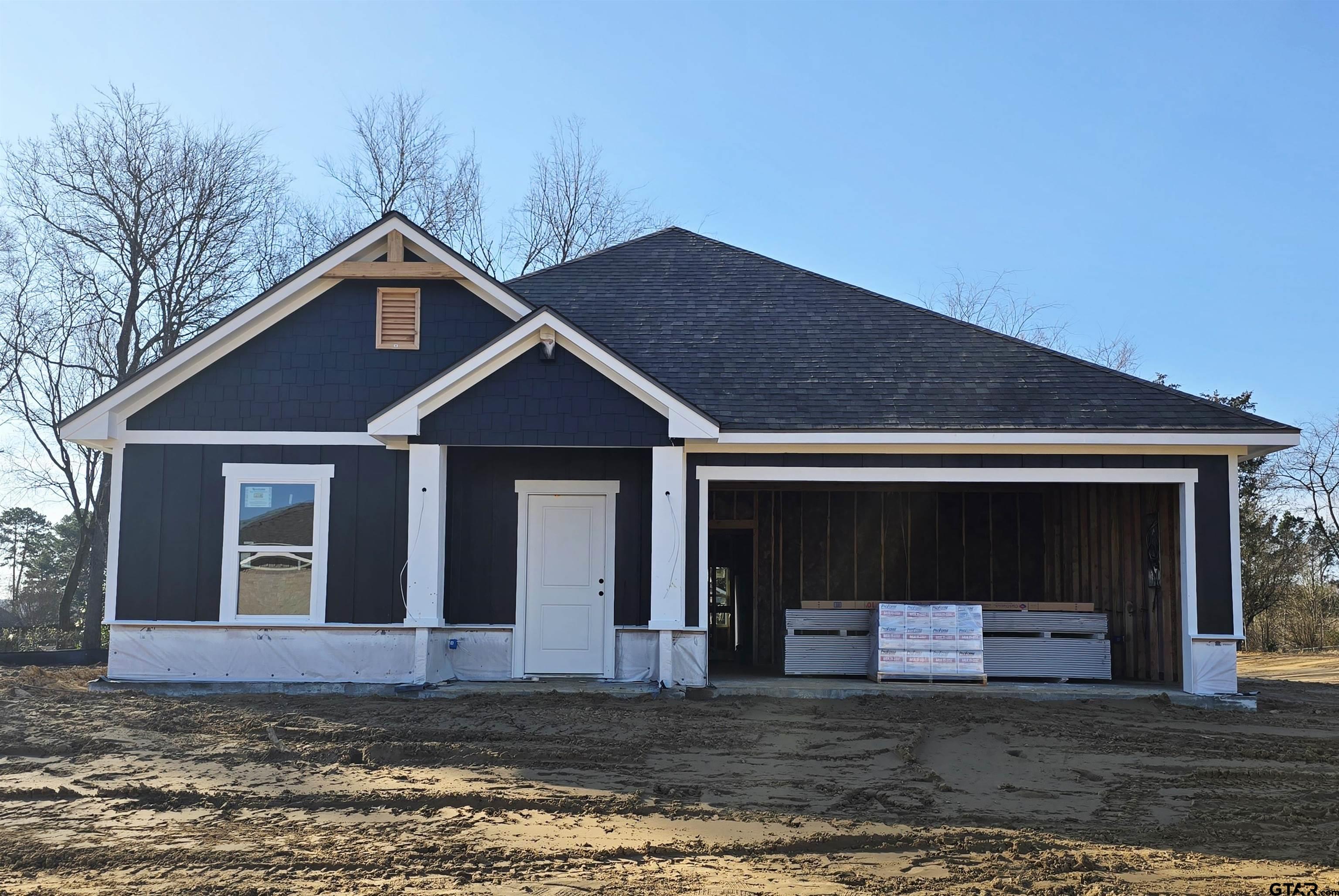 324 Erica Way Lindale, TX 75771 - Photo 3 of 14 a front view of a house with a yard and garage