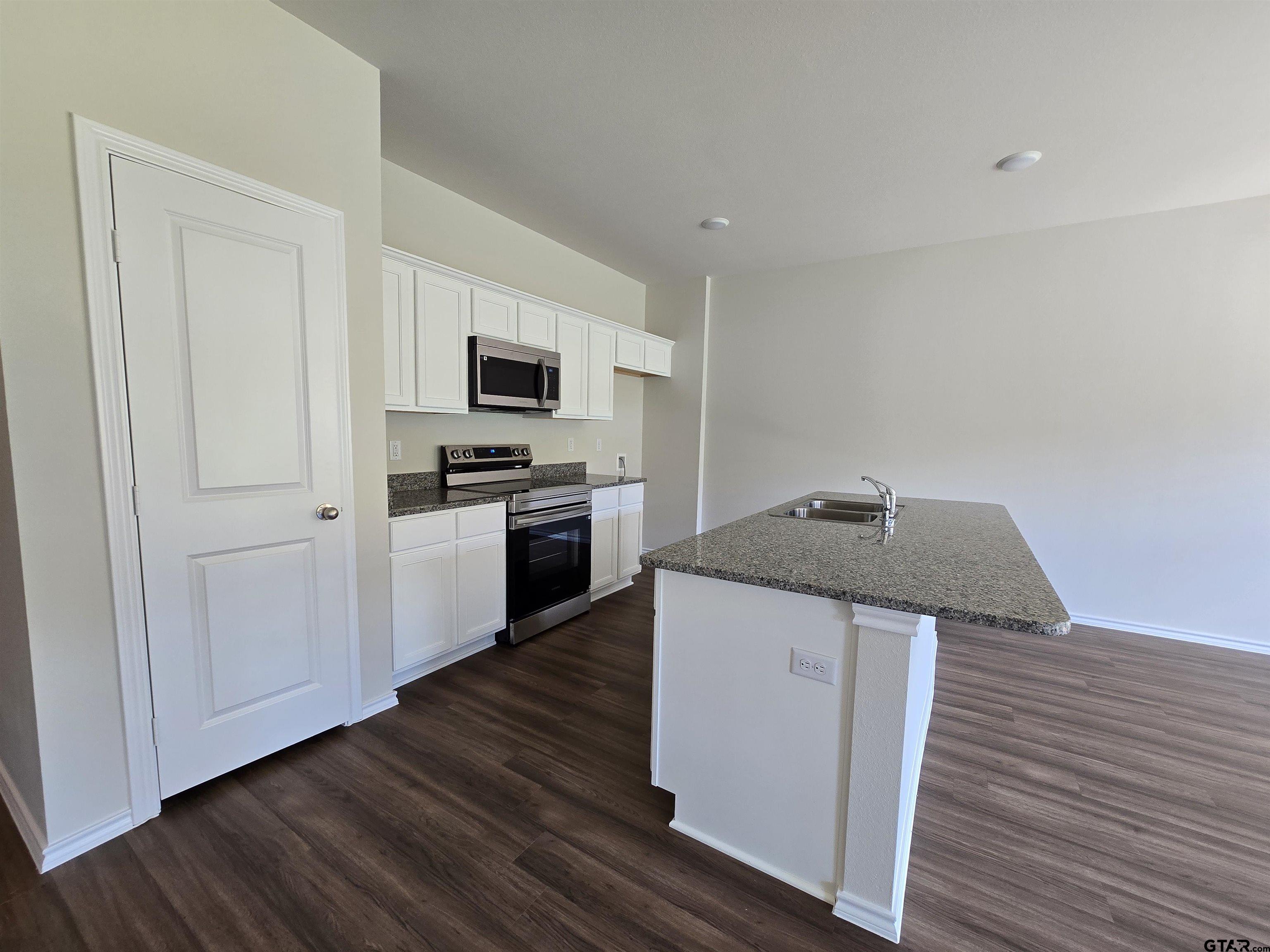 324 Erica Way Lindale, TX 75771 - Photo 5 of 14 a kitchen with a sink and steel appliances