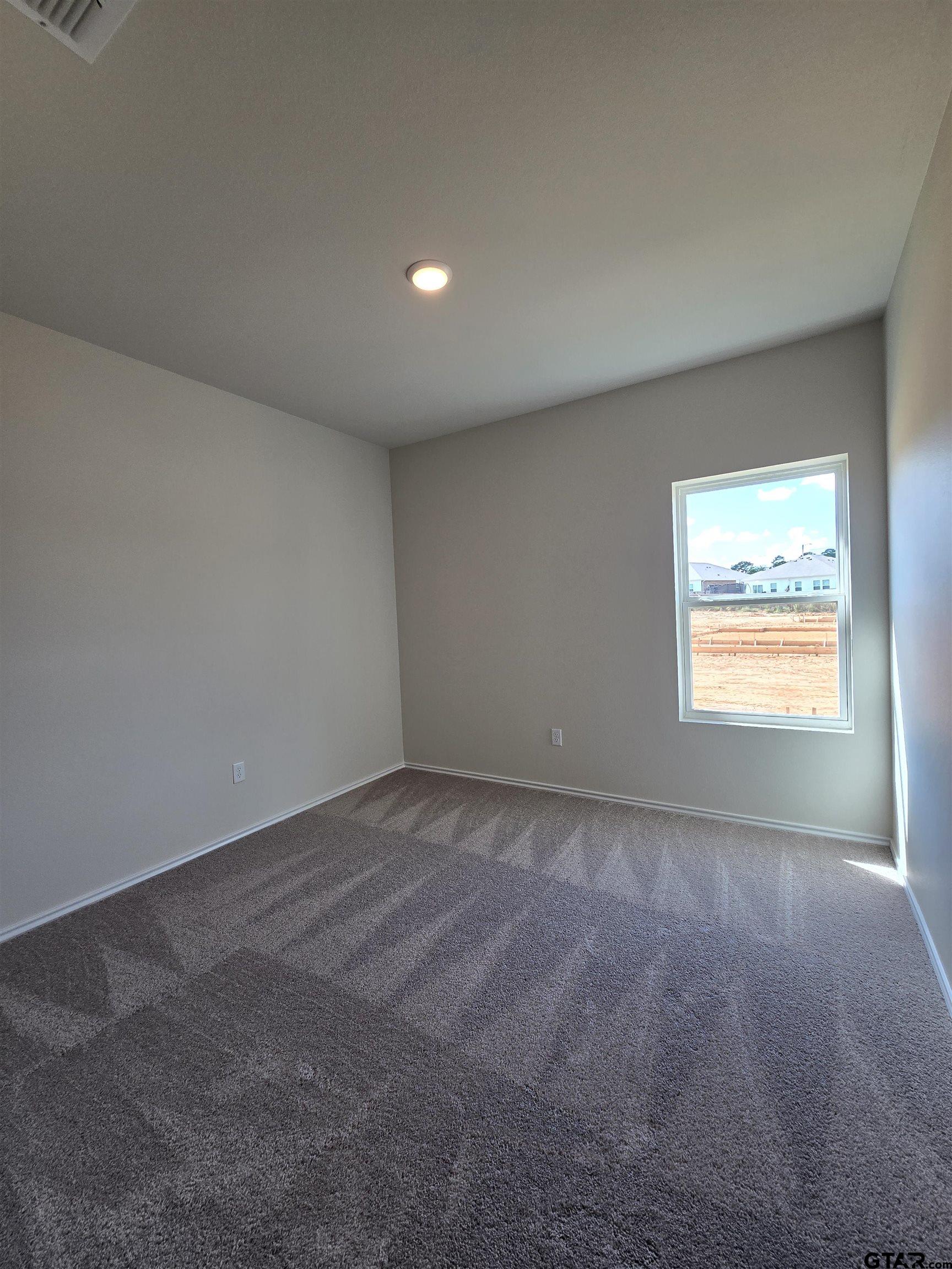 324 Erica Way Lindale, TX 75771 - Photo 9 of 14 a view of an empty room and a window