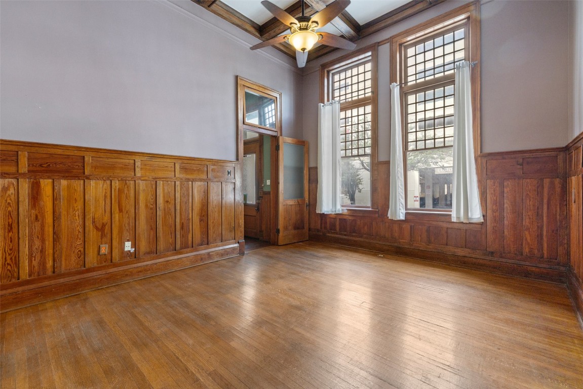 109 East 10th Street Austin, TX 78701 - Photo 6 of 38 a view of an empty room with a window and wooden floor