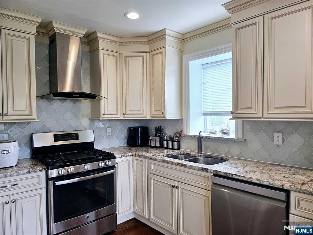 228 County Road, Unit 2 Tenafly, NJ 07670 - Photo 2 of 13 a kitchen with granite countertop a sink a stove and cabinets