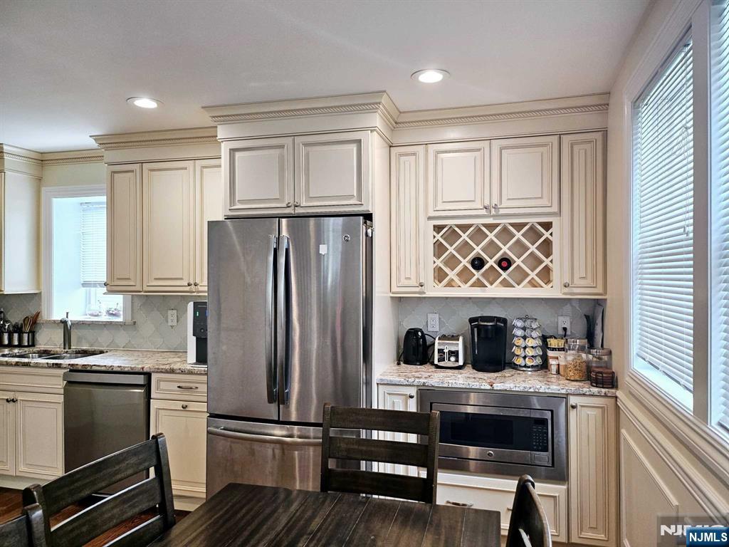 228 County Road, Unit 2 Tenafly, NJ 07670 - Photo 3 of 13 a kitchen with stainless steel appliances granite countertop a refrigerator and a stove top oven