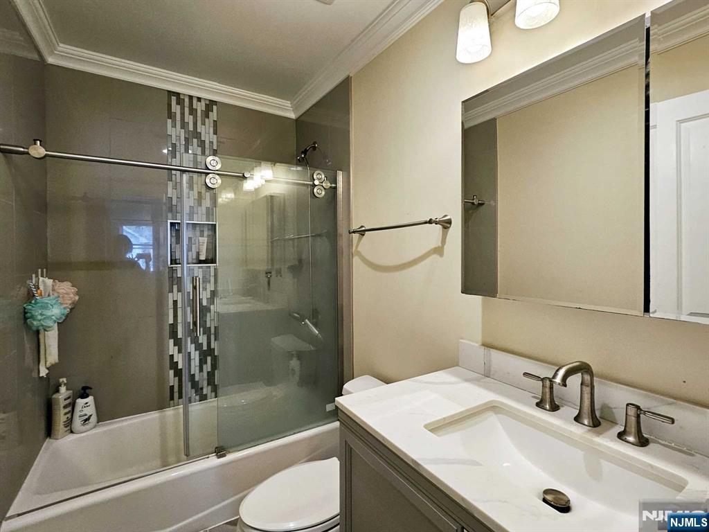 228 County Road, Unit 2 Tenafly, NJ 07670 - Photo 5 of 13 a bathroom with a sink toilet and shower
