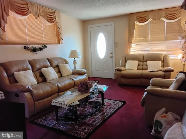 a living room with furniture lamp and a window