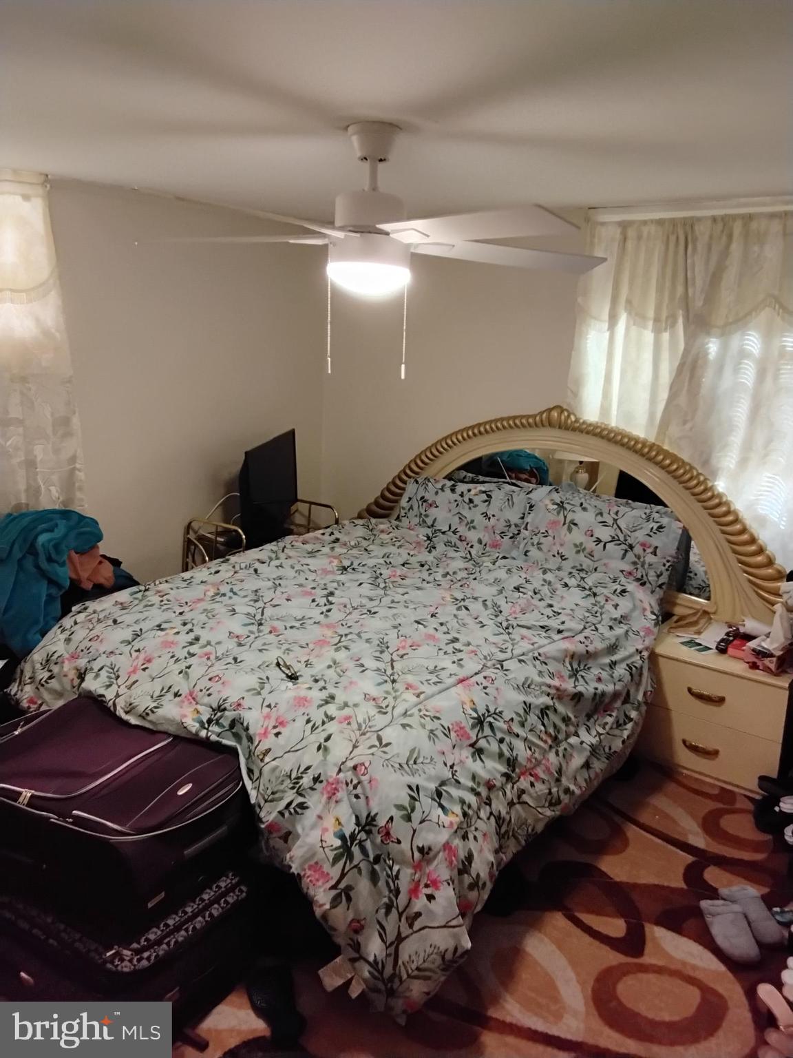 27 Concord Road Darby, PA 19023 - Photo 8 of 14 a bedroom with a bed and a chandelier