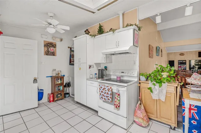 a kitchen with stainless steel appliances kitchen island granite countertop a sink and cabinets