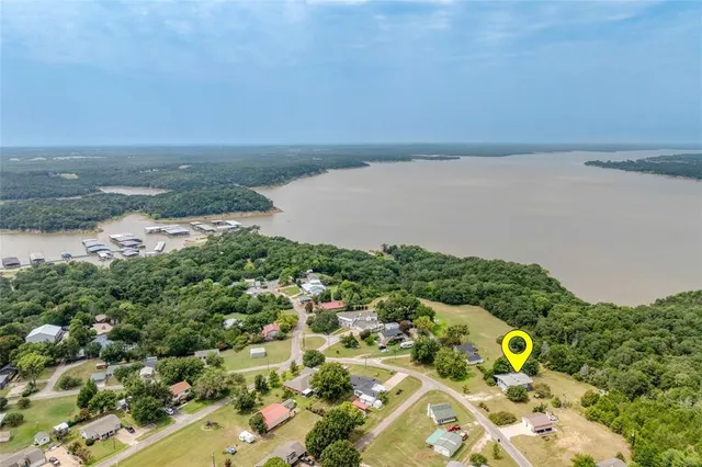 an aerial view of a houses with a lake view