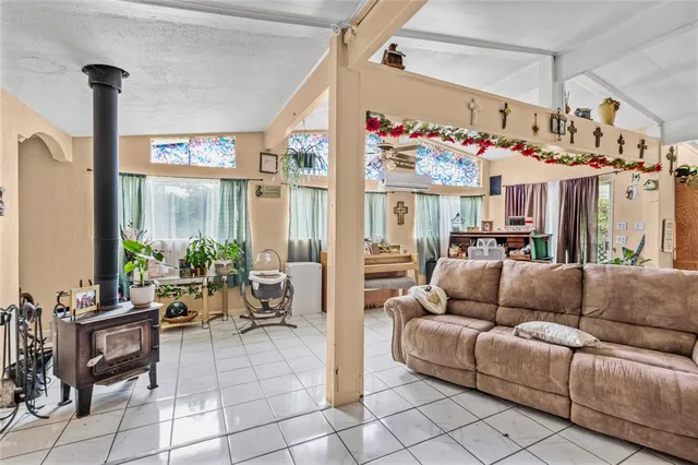 a living room with furniture and a floor to ceiling window