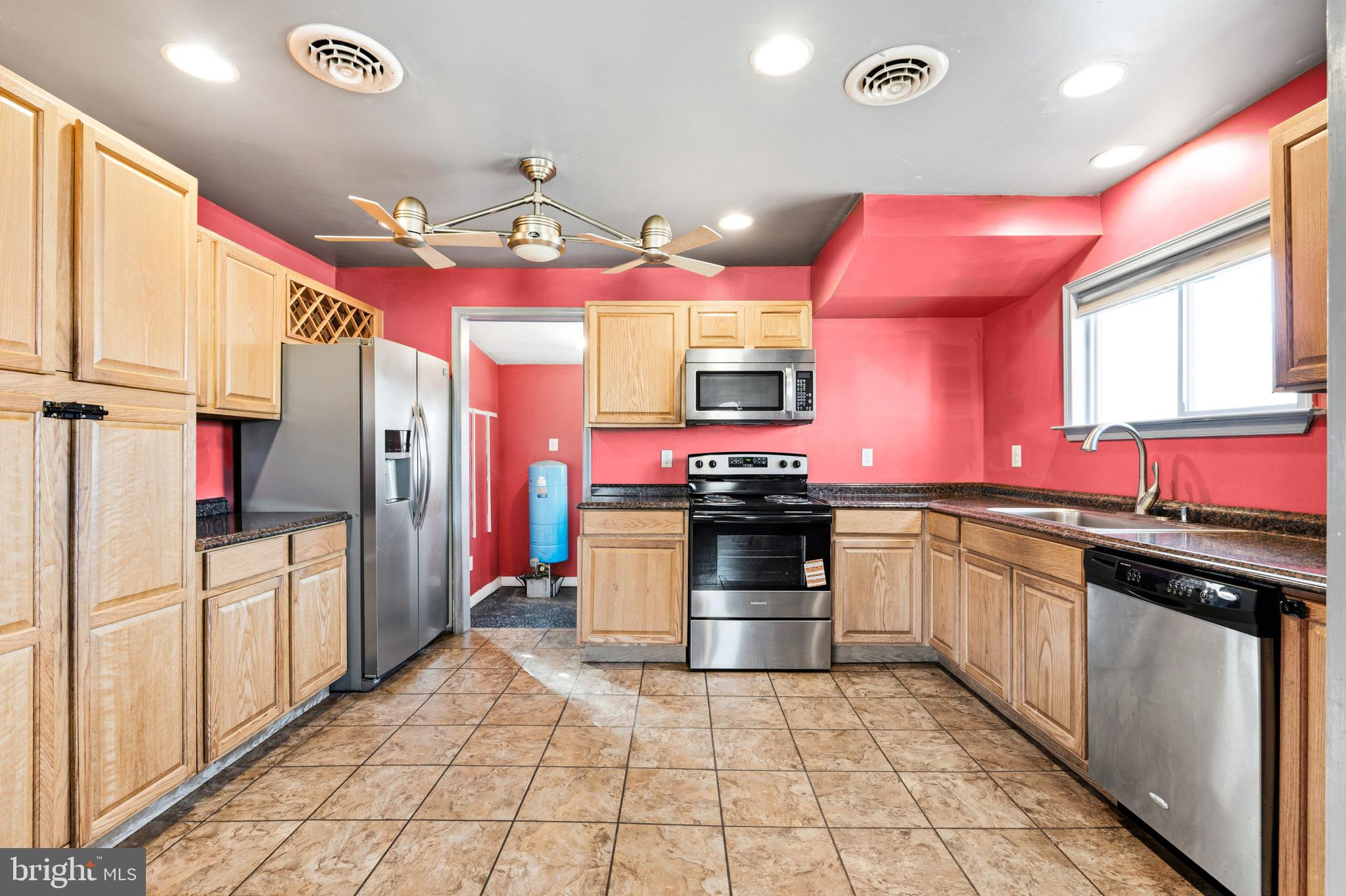 6156 Ripley Road La Plata, MD 20646 - Photo 13 of 26 a kitchen with stainless steel appliances granite countertop a sink and cabinets