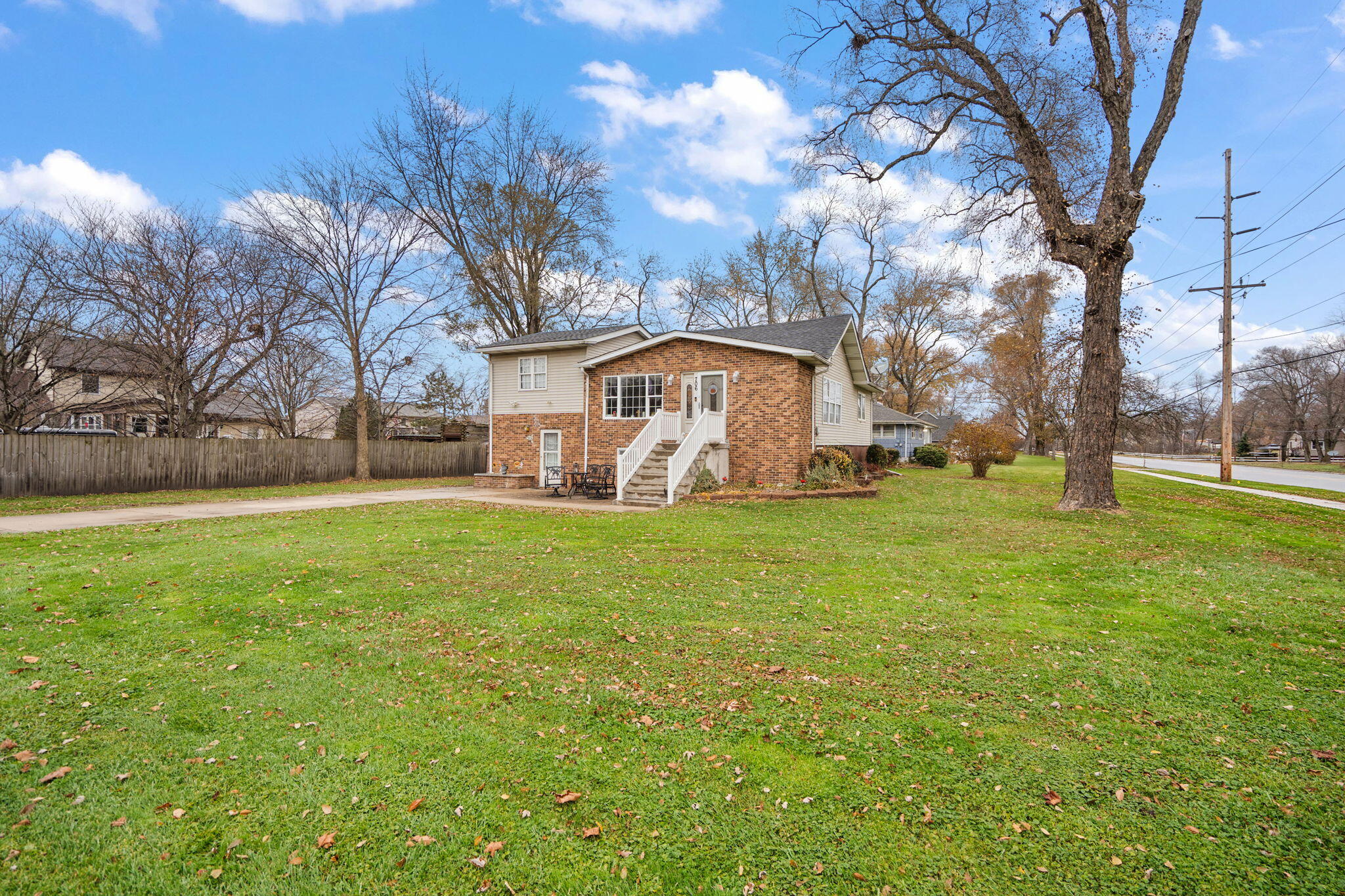 706 North Colfax Street Griffith, IN 46319 - Photo 24 of 25 a view of a white house that has a tree in front of it