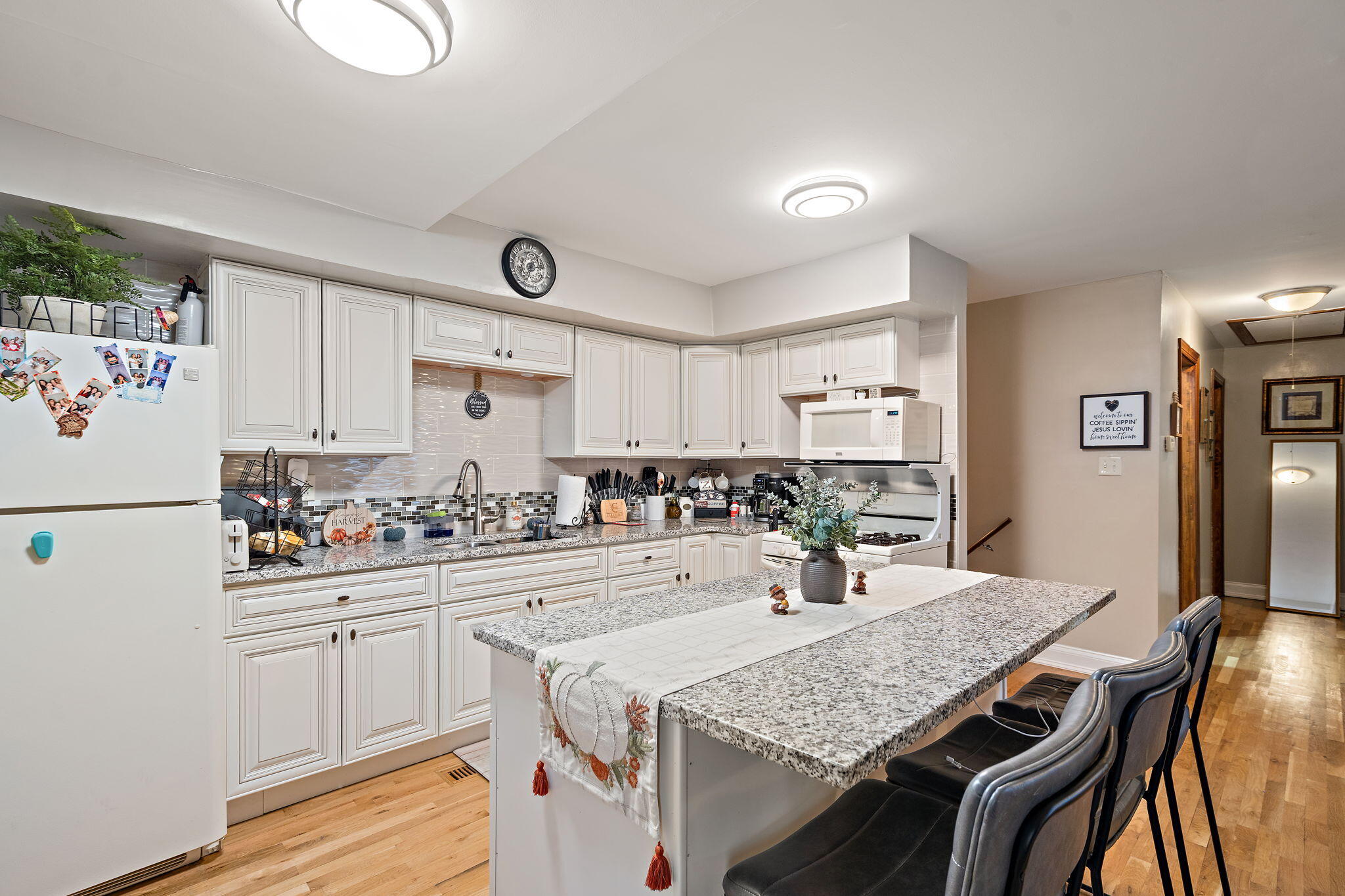 706 North Colfax Street Griffith, IN 46319 - Photo 4 of 25 a kitchen with a table chairs stove and refrigerator