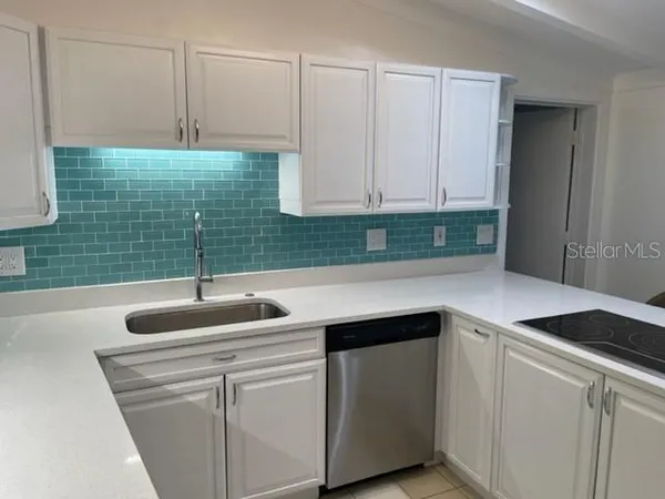 a kitchen with a sink and cabinets