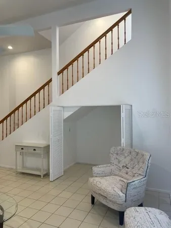a living room with furniture and stairs
