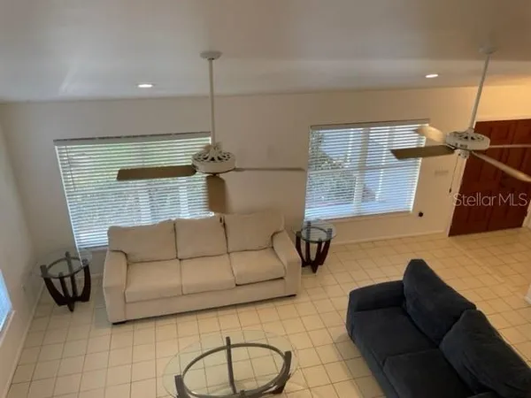 a living room with furniture a rug and a wall painting