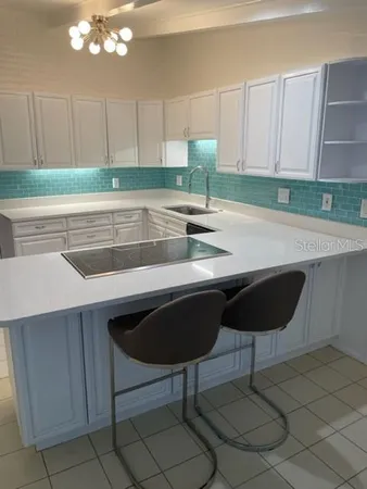 a kitchen with a sink cabinets and window