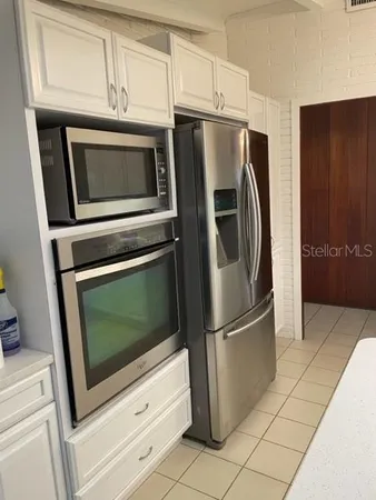 a kitchen with cabinets and stainless steel appliances