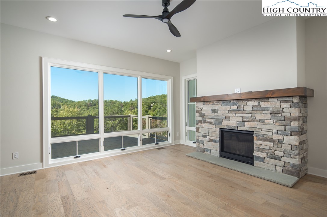 353 Calico Court Boone, NC 28607 - Photo 10 of 50 wooden floor fireplace and windows in an empty room