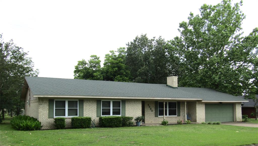 4530 Welch Circle Paris, TX 75462 - Photo 1 of 1 a front view of a house with a garden