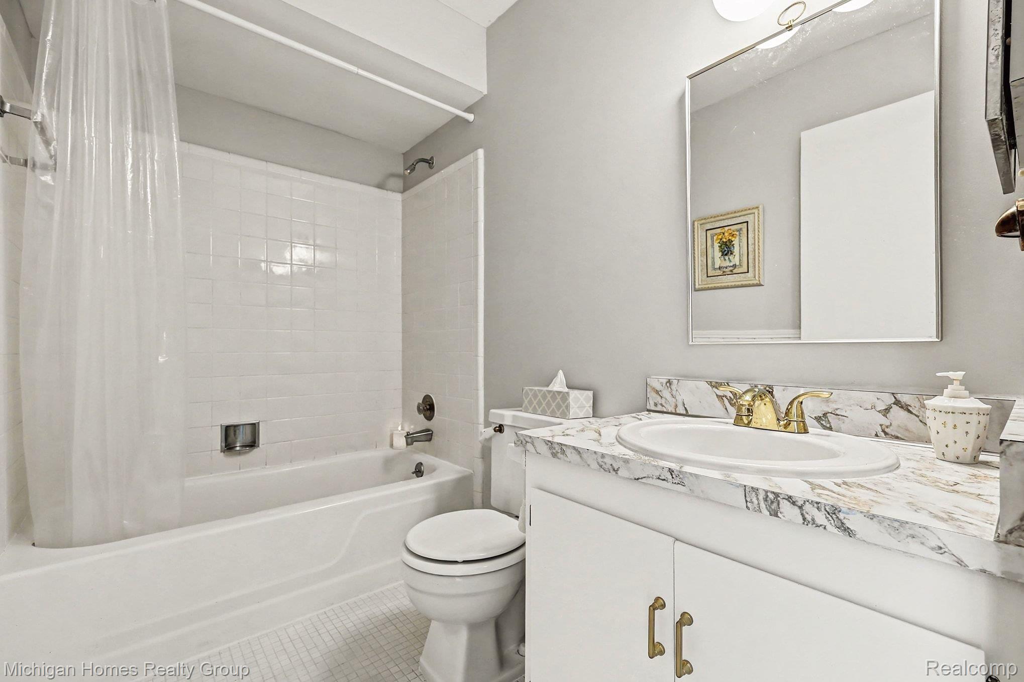 1437 Lantern Lane Rochester, MI 48306 - Photo 19 of 31 Bathroom featuring vanity, shower / tub combo, and tile patterned floors
