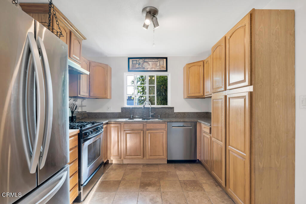 3151 Fournier Street Oxnard, CA 93033 - Photo 11 of 40 a kitchen with stainless steel appliances granite countertop a refrigerator a stove and a sink