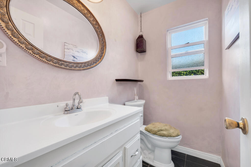 3151 Fournier Street Oxnard, CA 93033 - Photo 20 of 40 a bathroom with a sink a mirror and a toilet