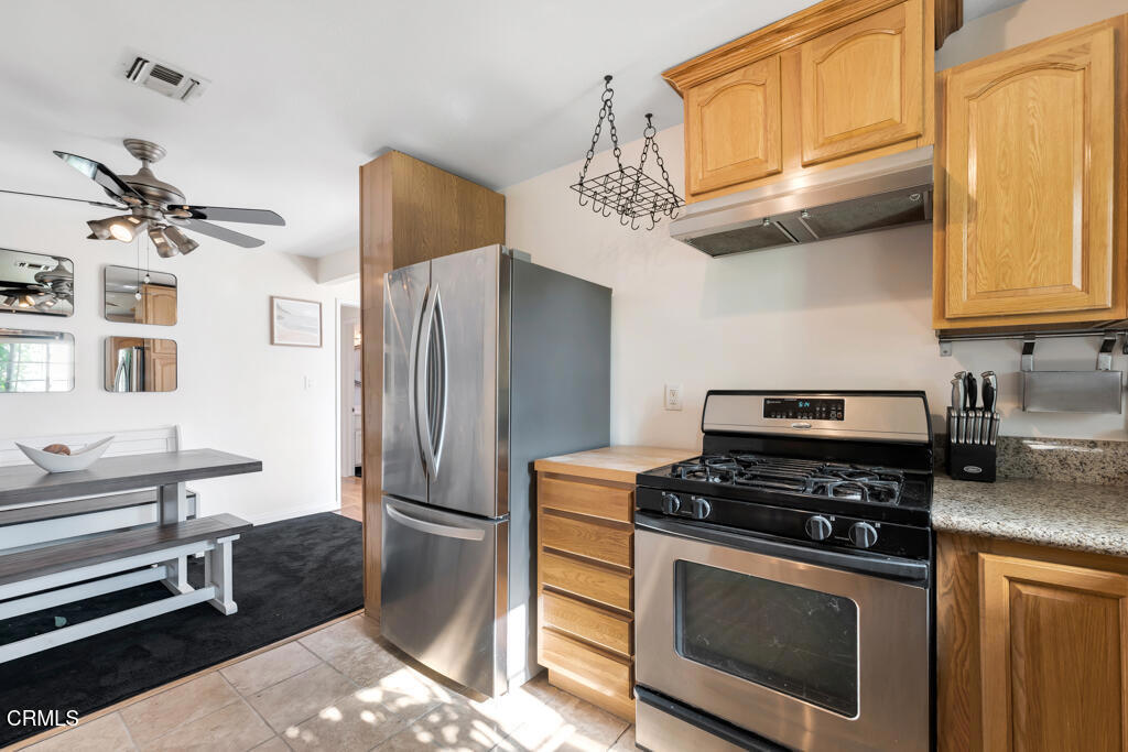 3151 Fournier Street Oxnard, CA 93033 - Photo 8 of 40 a kitchen with stainless steel appliances a stove a microwave and a refrigerator