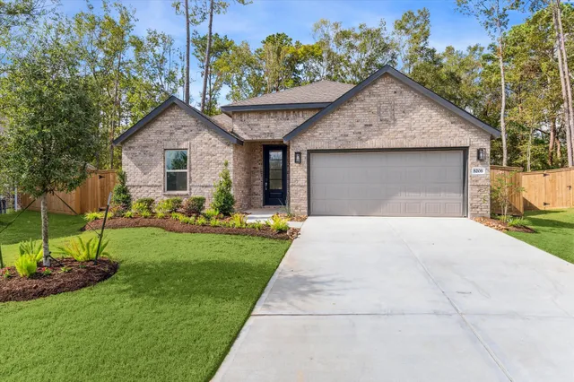 a front view of house with yard and green space