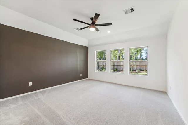 a view of a livingroom with a ceiling fan and window