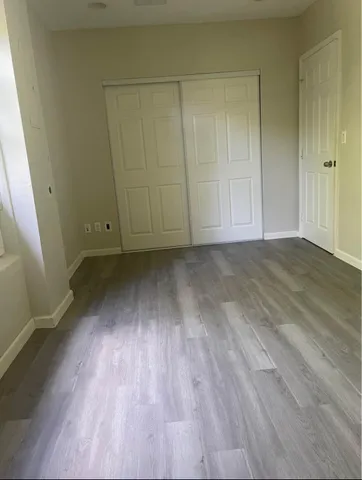 a view of a room with wooden floor