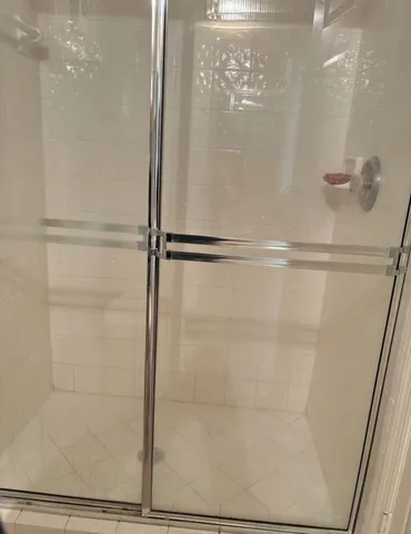 a bathroom with a glass shower door